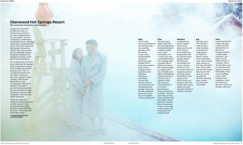 A photograph that spans the width two page layout for a magazine. on the left are a couple in bathrobes, w woman and man hold hands, the woman is staring up into the eyes fo the man. The left side of couple is a lifeguard chair and a column of text the is headlined Glenwood Hot Springs Resort to the right of the couple is a beautiful aqua blue hot steaming pool the steam covers the span of the photo with a faint but obvious point to the redstone building structure for the hot springs pool. 